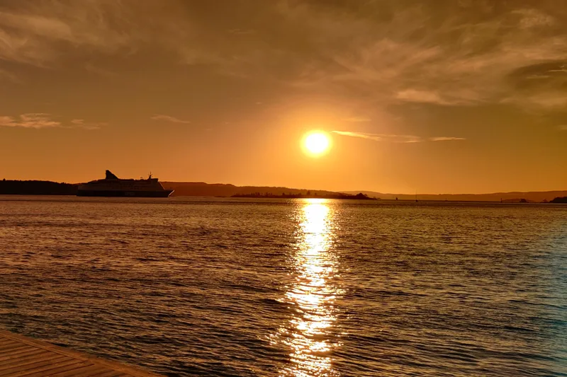 Sunset over the Oslofjord, with a ship in silhouette