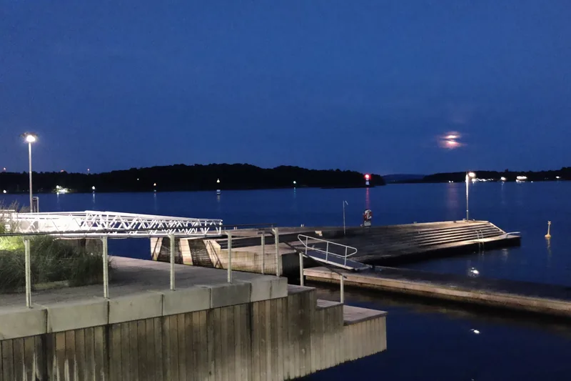 The sea bath on a summer night at blue hour, with empty platforms and steps down into the water