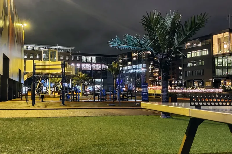 Trettenparken in the evening, with exercise equipment and artificial palm trees
