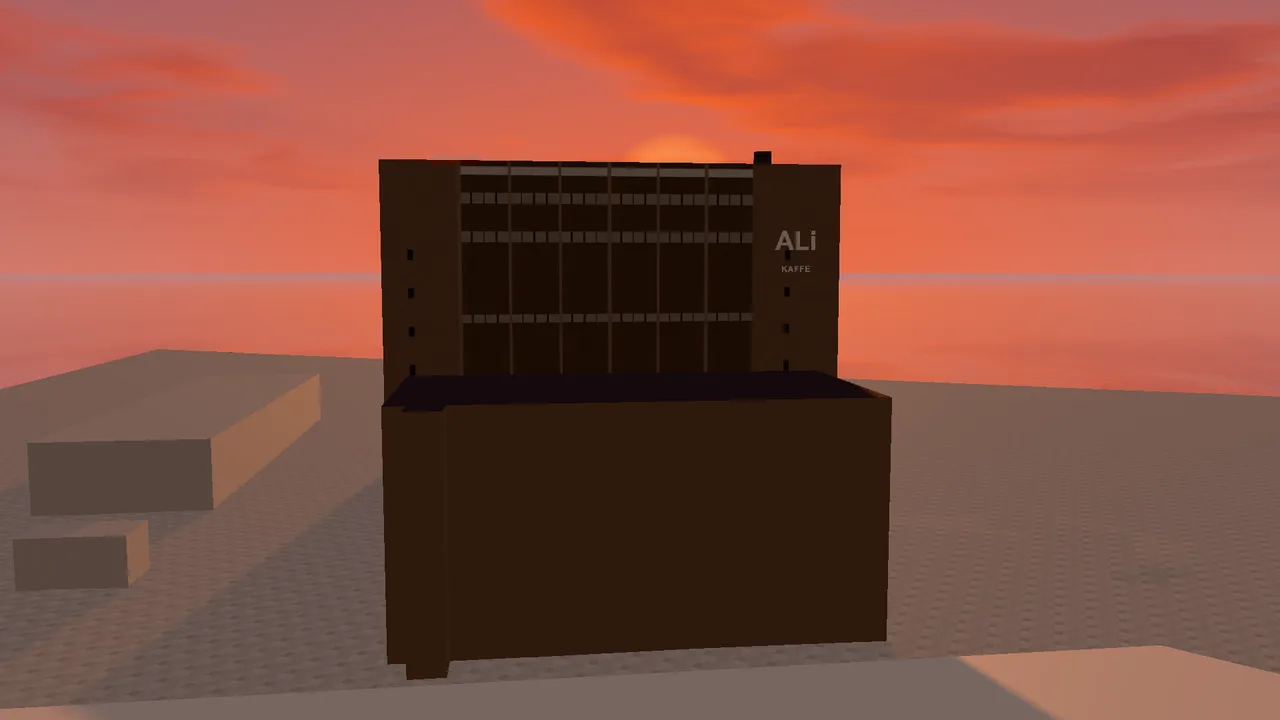 The ALI Building as a dark silhouette against the sunset.