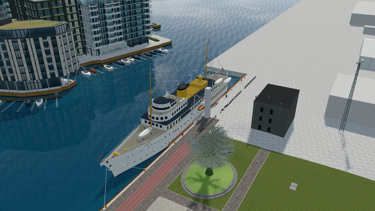 The Royal Yacht Norge at the quay at Filipstad, seen from above, with the Oslo Tree and Tjuvholmen around it.