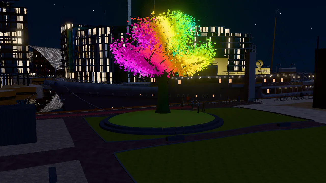 The Oslo Tree at night, with brightly coloured LED lights against the dark sky.