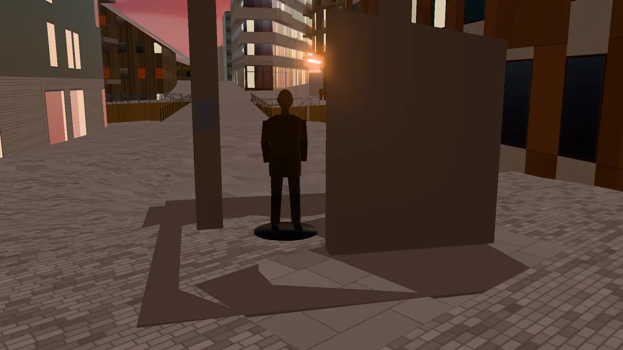 The statue of Olav Selvaag and the concrete portal in evening light, with the homes around the square.